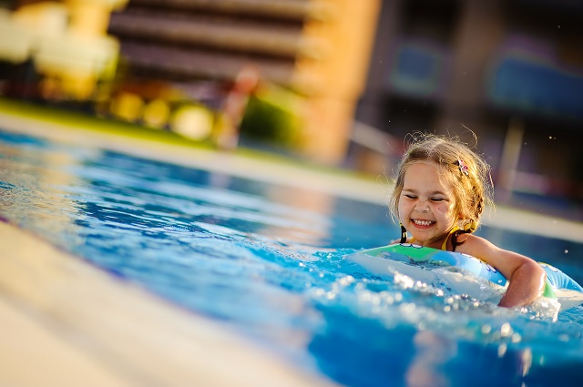 A Girl Swimming in Outdoor Pool